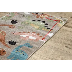 Soft children's rug with dinosaurs, perfect for playtime, cozy texture